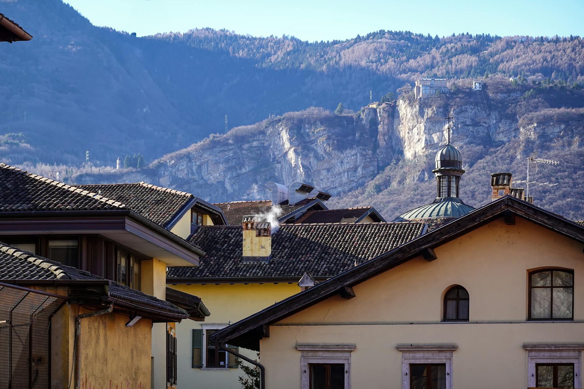 Charming Italian village roofs with mountain views create a scenic and serene landscape.